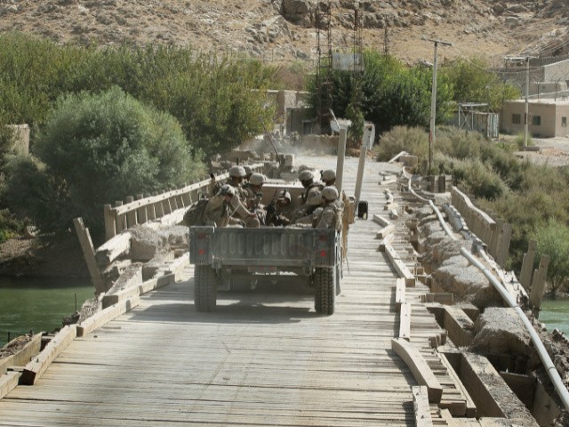 U.S. Marine with India Battery, 3rd Battalion, 12th Marine Regiment cross the Helmand River bridge in a Humvee following a patrol near Forward Operating Base (FOB) Zeebrugge on October 13, 2010 in Kajaki, Afghanistan. The Marines of India Battery, 3rd Battalion, 12th Marine Regiment are responsible for securing the area near the Kajaki Dam on the Helmand River. (Photo by Scott Olson/Getty Images)
