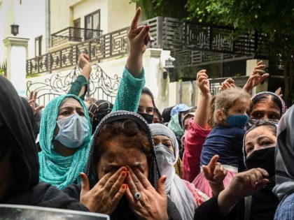 Afghans residing in India take part in a demonstration outside the UN Refugee Agency ( UNH