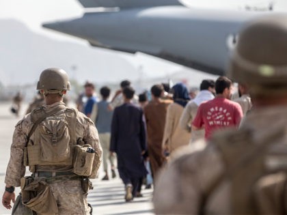 In this Aug. 21, 2021, photo provided by the U.S. Marine Corps, Marines with Special Purpose Marine Air-Ground Task Force-Crisis Response-Central Command (SPMAGTF-CR-CC) guide evacuees on to a U.S. Air Force Boeing C-17 Globemaster III during an evacuation at Hamid Karzai International Airport in Kabul, Afghanistan. (Sgt. Samuel Ruiz/U.S. Marine …
