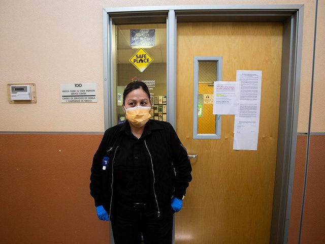 A security guard at the Mecca Health Clinic in Mecca, California wears a mask to protect herself from COVID-19. Farmers16513