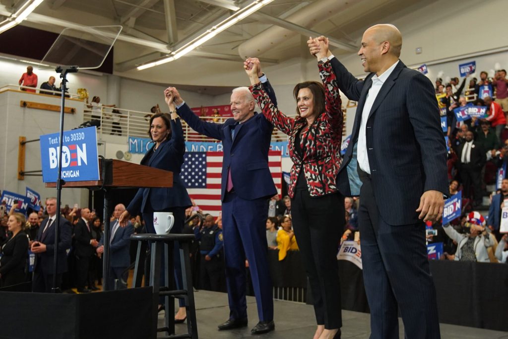 (Left to right) U.S. Sen. Kamala Harris of California, Democratic presidential candidate and former Vice President Joe Biden, Michigan Governor Gretchen Whitmer and U.S. Sen. Cory Booker raise arms after Biden takes the stage to speak to a crowd during a Get Out the Vote event at Renaissance High School in Detroit on March 9, 2020.