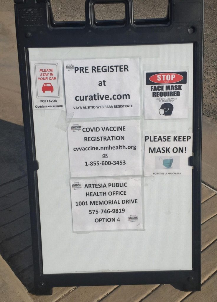 A sign at a drive thru COVID-19 clinic at the Eddy County Public Health Office in Artesia reminds people to register before getting tested or receiving a vaccine. (Mike Smith Current-Argus via Imagn Content Services, LLC)