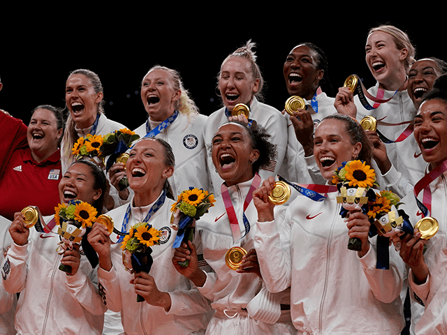 USA players on the podium with their gold medals after defeating Brazil in the women's volleyball gold medal match during the Tokyo 2020 Olympic Summer Games at Ariake Arena.