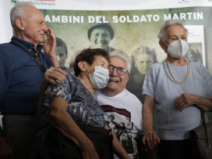 A 97 year old retired American soldier Martin Adler poses with Giulio, left, Mafalda, right, and Giuliana Naldi that he saved during a WWII at Bologna's airport, Italy, Monday, Aug. 23, 2021. For more than seven decades, Martin Adler treasured a back-and-white photo of himself as a young soldier with …