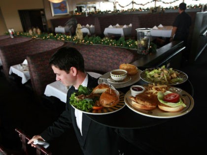 SAN FRANCISCO - DECEMBER 03: Waiter Alexander Alioto prepares to serve lunch to customers at Alioto's Seafood Restaurant December 3, 2008 in San Francisco, California. A report by The Institute for Supply Management says that its services sector index dropped in November to 37.3, down from 44.4 in October as …