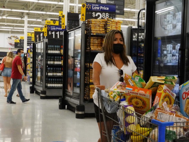 People wearing protective masks shop in a Walmart store on May 18, 2021 in Hallandale Beac