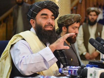 Taliban spokesperson Zabihullah Mujahid (L) gestures as he speaks during the first press conference in Kabul on August 17, 2021 following the Taliban stunning takeover of Afghanistan. (Photo by Hoshang Hashimi / AFP) (Photo by HOSHANG HASHIMI/AFP via Getty Images)