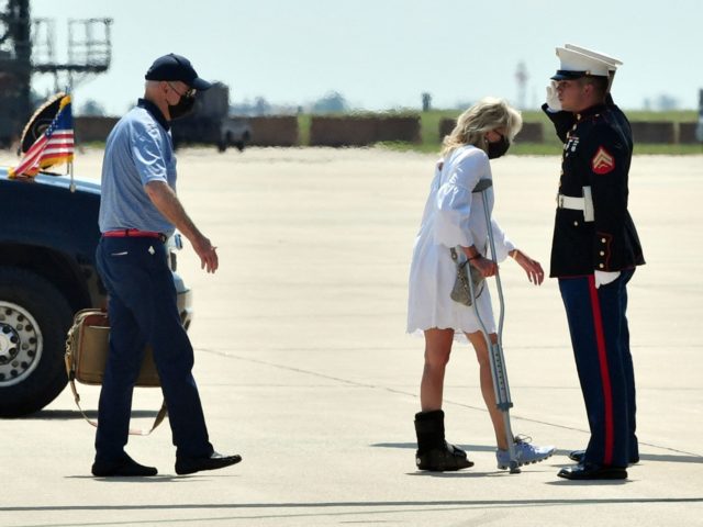 US President Joe Biden (L) and First Lady Jill Biden (C) board Marine One at Delaware Air National Guard in New Castle, Delaware, on August 13, 2021, as they travel to Camp David, Maryland. - Jill Biden injured her left foot in Oahu, Hawaii, the last weekend in July, while …