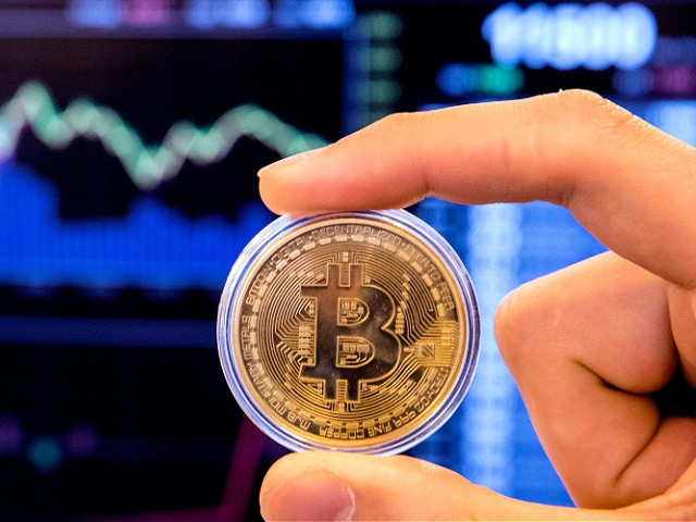 An Israeli holds a visual representation of the digital cryptocurrency Bitcoin, at the "Bitcoin Change" shop in the Israeli city of Tel Aviv on January 17, 2018. - At the end of 2017 Israel Securities Authority said it was moving to ban trading in cryptocurrency-based companies on the Tel Aviv market until transactions involving digital coins are legally regulated. (Photo by JACK GUEZ / AFP) (Photo by JACK GUEZ/AFP via Getty Images)