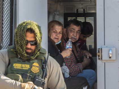 YUMA, AZ - MAY 13: A family of asylum seekers from Colombia boards the Border Patrol Inmate transport after they turned themselves in to US Border Patrol agents on May 13, 2021 in Yuma, Arizona. The Biden administration is trying to develop a plan to safely handle the surge of …
