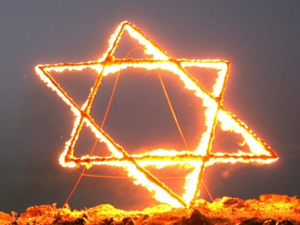 Israeli settlers burning a Star of David on the top of a mountain next to their outpost of Maale Rehavam, 23 May 2006, during a march of some one Hundred settlers and their supporters protesting against the wish of Israeli Prime Minister Ehud Olmert to uproot settlers. US President George …