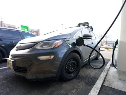 A Chevrolet Bolt is charged at a charging station at Colorado Mills Outlet Mall Monday, De