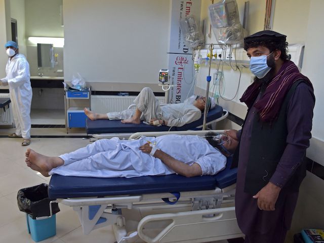In this photograph taken on June 8, 2021, a family member stands next to a Covid-19 coronavirus patient at the intensive care unit (ICU) of the Muhammed Ali Jinnah hospital in Kabul. - Officially Afghanistan has recorded fewer than 90,000 infections, with around 3,400 deaths, but health experts say a lack of testing and the refusal of patients to seek treatment hides the true figures. - To go with AFP story Afghanistan-Health-Virus, FOCUS by Mushtaq MOJADDIDI (Photo by Wakil KOHSAR / AFP) / To go with AFP story Afghanistan-Health-Virus, FOCUS by Mushtaq MOJADDIDI (Photo by WAKIL KOHSAR/AFP via Getty Images)