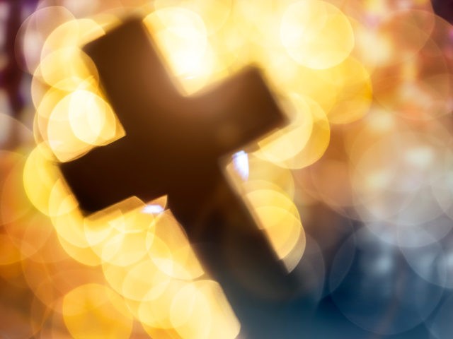 Abstract cross in church interior - stock photo Abstract defocussed crucifixion cross silh