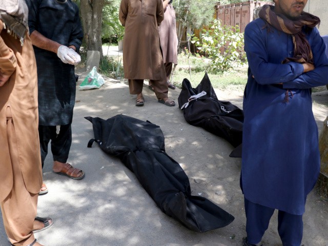 Dead bodies of Afghans are laid down on the ground at a hospital in Kabul, Afghanistan, Friday, Aug. 27, 2021, a day after deadly attacks outside the airport. Two suicide bombers and gunmen attacked crowds of Afghans flocking to Kabul's airport Thursday, transforming a scene of desperation into one of horror in the waning days of an airlift for those fleeing the Taliban takeover. (AP Photo/Wali Sabawoon)