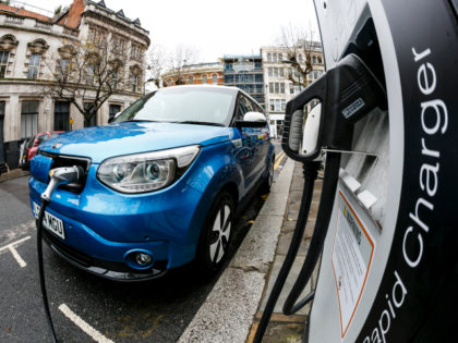 Go Ultra Low Kia Soul EV on charge on a London street. Ultra-low emission vehicles such as this can cost as little as 2p per mile to run and some electric cars and vans have a range of up to 700 miles.