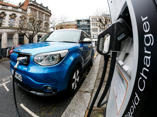 Go Ultra Low Kia Soul EV on charge on a London street. Ultra-low emission vehicles such as this can cost as little as 2p per mile to run and some electric cars and vans have a range of up to 700 miles.
