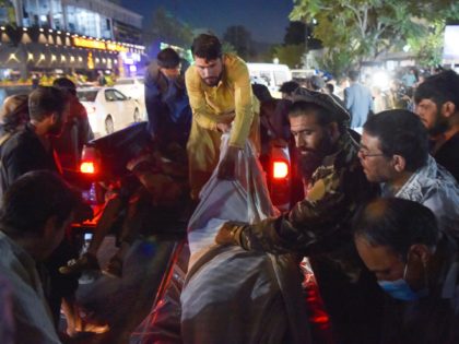 EDITORS NOTE: Graphic content / TOPSHOT - Volunteers and medical staff unload bodies from a pickup truck outside a hospital after two powerful explosions, which killed at least six people, outside the airport in Kabul on August 26, 2021. (Photo by Wakil KOHSAR / AFP) (Photo by WAKIL KOHSAR/AFP via …