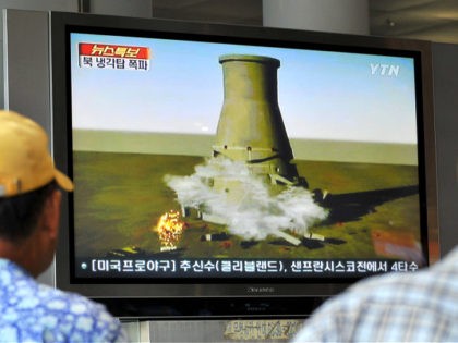 South Koreans watch a TV news programme at a railway station in Seoul, on June 27, 2008 that shows a mock video of the planned blow-up of a cooling tower at North Korea's Yongbyon nuclear complex. Secretive North Korea was preparing a global TV spectacular to dramatise its commitment to …