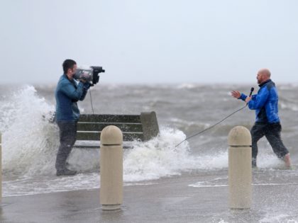 A news crew films as storm surge pushes water from Lake Pontchartrain over Lakeshore Drive as the effects of Hurricane Ida begin to be felt in New Orleans on Sunday, Aug. 29, 2021. Nolaidasun07