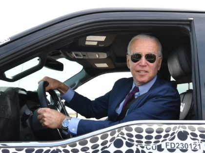 TOPSHOT - US President Joe Biden drives the new electric Ford F-150 Lightning at the Ford Dearborn Development Center in Dearborn, Michigan on May 18, 2021. (Photo by Nicholas Kamm / AFP) (Photo by NICHOLAS KAMM/AFP via Getty Images)