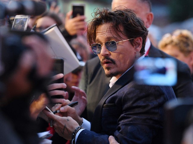 VENICE, ITALY - SEPTEMBER 06: Johnny Depp signs autographs on the red carpet ahead of the "Waiting For The Barbarians" screening during the 76th Venice Film Festival at Sala Grande on September 06, 2019 in Venice, Italy. (Photo by Pascal Le Segretain/Getty Images)