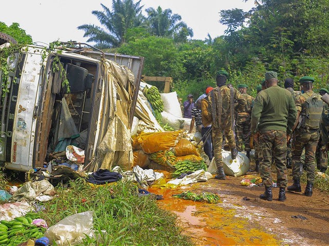 Congolese Defense Forces soldiers inspect the scene of an attack near the town of Oicha, 3