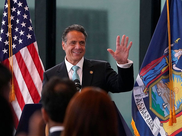 New York Governor Andrew Cuomo waves during an event to announce that New York will lift '