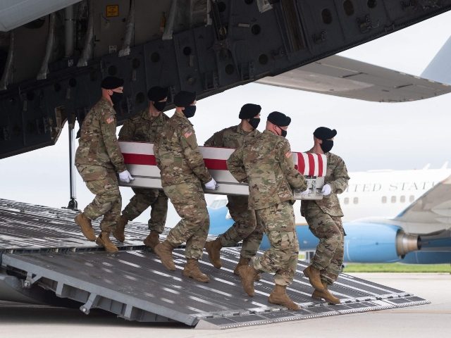 A transfer case with the remains of Army Staff Sgt. Ryan C. Knauss, 23, of Corryton, Tennessee, are carried off of a military aircraft as US President Joe Biden attends the dignified transfer at Dover Air Force Base in Dover, Delaware, August, 29, 2021, one of the 13 members of …
