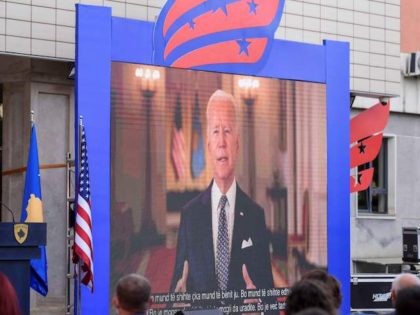 US President Joe Biden appears on screen in Pristina on August 1, 2021, on a pre-tapped me