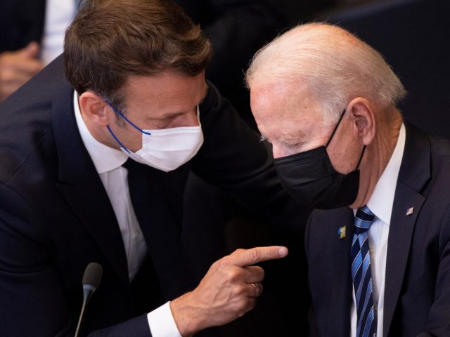 France's President Emmanuel Macron (L) talks to US President Joe Biden before a meeting of the North Atlantic Council at the North Atlantic Treaty Organization (NATO) headquarters in Brussels on June 14, 2021. - The 30-nation alliance hopes to reaffirm its unity and discuss increasingly tense relations with China and …