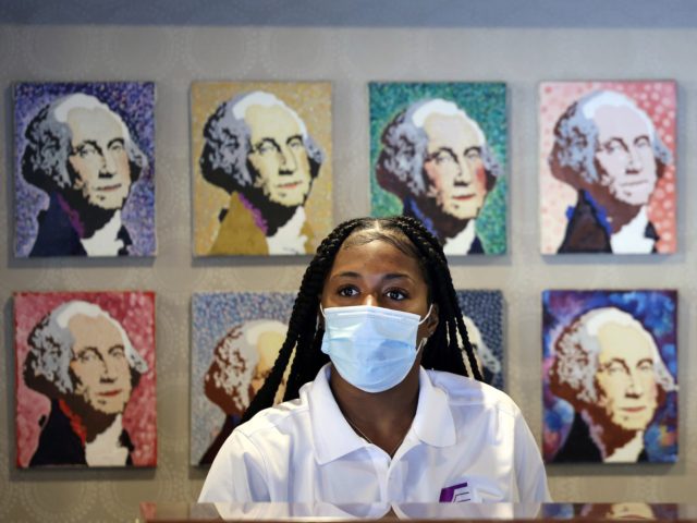 WASHINGTON, DC - JULY 30: A hotel employee wears a mask inside a lobby on July 30, 2021 in Washington, DC. DC Mayor Muriel Bowser restored a COVID-19 indoor mask mandate, regardless of vaccination status, starting Saturday. (Photo by Kevin Dietsch/Getty Images)