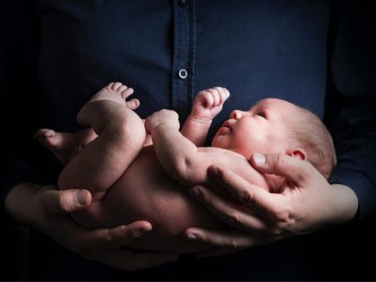 holding newborn baby