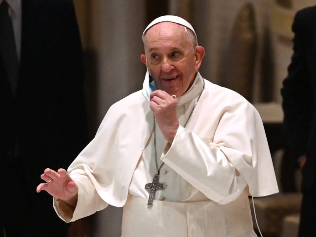 Pope Francis gestures as he adjusts his facemask during his weekly general audience at Pau