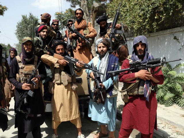 Taliban fighters pose for a photograph in Kabul, Afghanistan, Thursday, Aug. 19, 2021. The