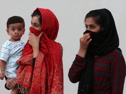 This picture taken during a media visit organised by the Qatari authorities on August 21, 2021, shows Afghan women and a child inside a villa complex near the centre of the Qatari capital Doha, where refugees who recently arrived from Afghanistan began to settle, following their exodus from their country …