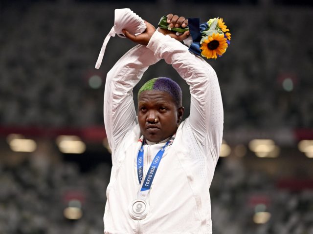 econd-placed USA's Raven Saunders gestures on the podium with her silver medal after competing the women's shot put event during the Tokyo 2020 Olympic Games at the Olympic Stadium in Tokyo on August 1, 2021. (Photo by Ina FASSBENDER / AFP) (Photo by INA FASSBENDER/AFP via Getty Images)