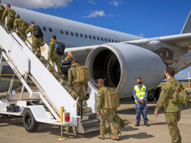 A contingent of Air Force and Army personnel board a waiting KC-30A Multi-Role Tanker Tran