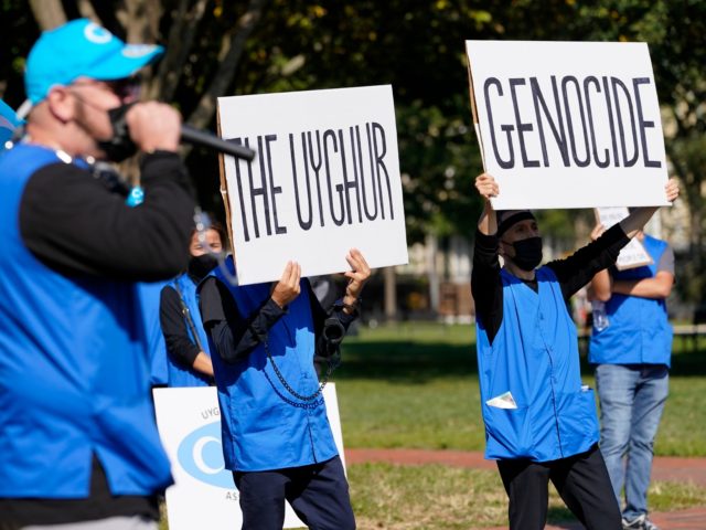 Holding signs saying "Stop the Uyghur Genocide," members of the Uyghur American Association rally in front of the White House, Thursday, Oct. 1, 2020, after marching from Capitol Hill in Washington, in support of the Uyghur Forced Labor Prevention Act which has passed the House and now will go on …