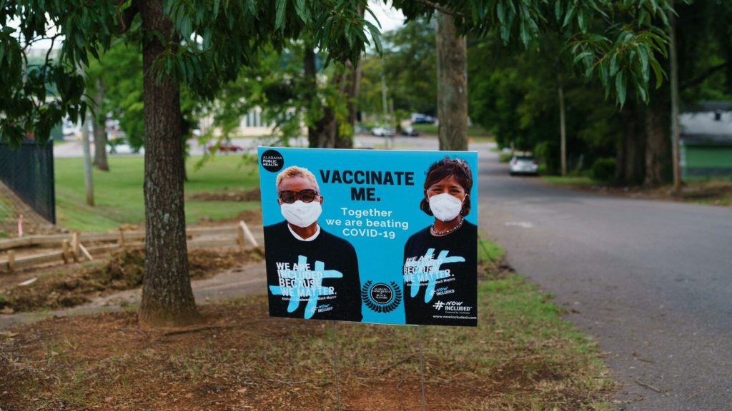 A sign encouraging COVID-19 vaccination is seen outside a park on June 30, 2021, in Birmingham, Alabama. - A black minority suspicious of vaccines in general, and conservative white rural people convinced that the vaccine is more dangerous than Covid-19: Alabama and several southern states in the United States have among the lowest vaccination rates, making this deprived region an Achilles heel in the face of the coronavirus. (Photo by Elijah Nouvelage / AFP) (Photo by ELIJAH NOUVELAGE/AFP via Getty Images)