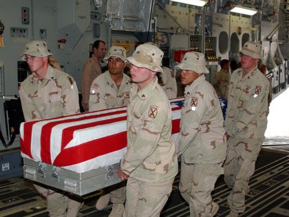 KANDAHAR AIR FIELD, AFGHANISTAN - U.S. Army soldiers assigned to the 10th Mountain Division load a flag draped coffin bearing the remains of a fellow soldier onto a transport plane at Kandahar Air Field, Afghanistan in this photo released April 28, 2005 by the Pentagon. The release this week of …
