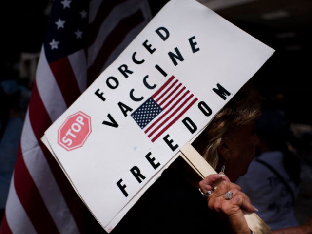 Anti-vaccine rally protesters hold signs outside of Houston Methodist Hospital in Houston, Texas, on June 26, 2021. - A spokesperson for Houston Methodist Hospital said on June 23, 153 employees either resign or were fired for refusing to be vaccinated. (Photo by Mark Felix / AFP) (Photo by MARK FELIX/AFP …