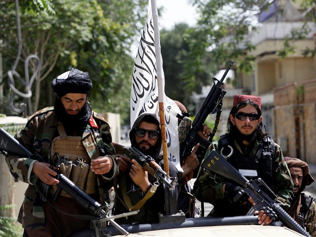 Taliban fighters display their flag on patrol in Kabul, Afghanistan, Thursday, Aug. 19, 2021. The Taliban celebrated Afghanistan's Independence Day on Thursday by declaring they beat the United States, but challenges to their rule ranging from running a country severely short on cash and bureaucrats to potentially facing an armed …