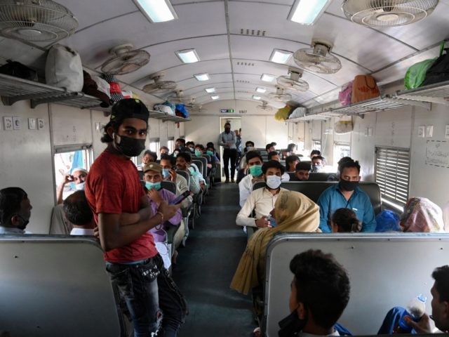 Passengers sit in a train as they travel to their hometowns during the holy month of Ramad