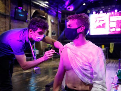 LONDON, ENGLAND - AUGUST 08: A man receives a dose of the Pfizer vaccine at an NHS Covid-19 vaccination centre hosted at the nightclub Heaven on August 8, 2021 in London, England. From late September, the UK government plans to require that patrons show proof of full vaccination to enter …