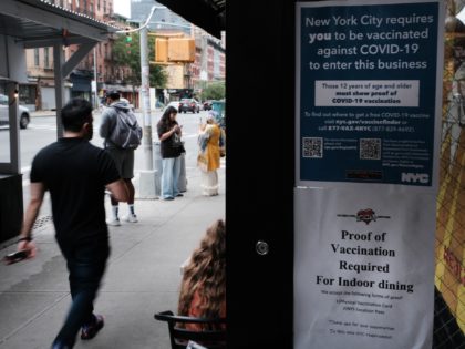 NEW YORK, NEW YORK - AUGUST 20: A sign in a restaurant window informs customers that they will need to show proof that they are at least partly vaccinated for Covid-19 to be allowed in the business on August 20, 2021 in New York City. New York City has begun …