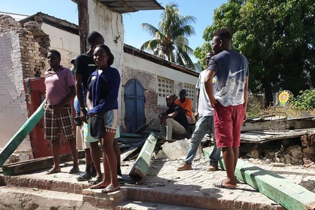 People survey destroyed houses in the hard-hit city of Jeremie, Haiti on August 14, 2021 f