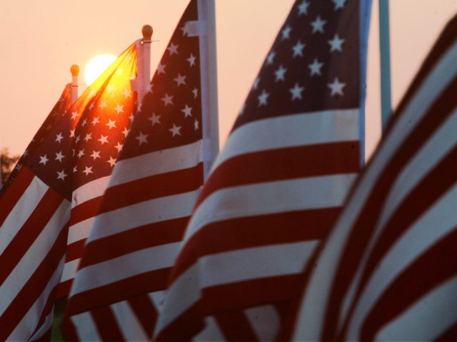 The sun rises over the Healing Field display with over 3000 American flags in memory of th