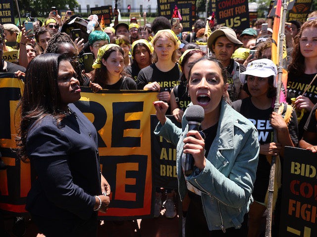 Reps. Cori Bush (D-MO) and Alexandria Ocasio-Cortez (D-NY) rally young climate activists in Lafayette Square on the north side of the White House to demand President Joe Biden works to make the Green New Deal into law on June 28, 2021, in Washington, DC. (Chip Somodevilla/Getty Images)