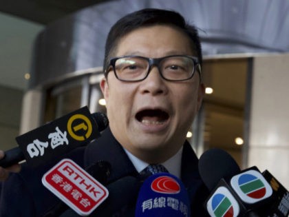 Hong Kong new Police Chief Chris Tang talks to journalists outside a hotel before leaving